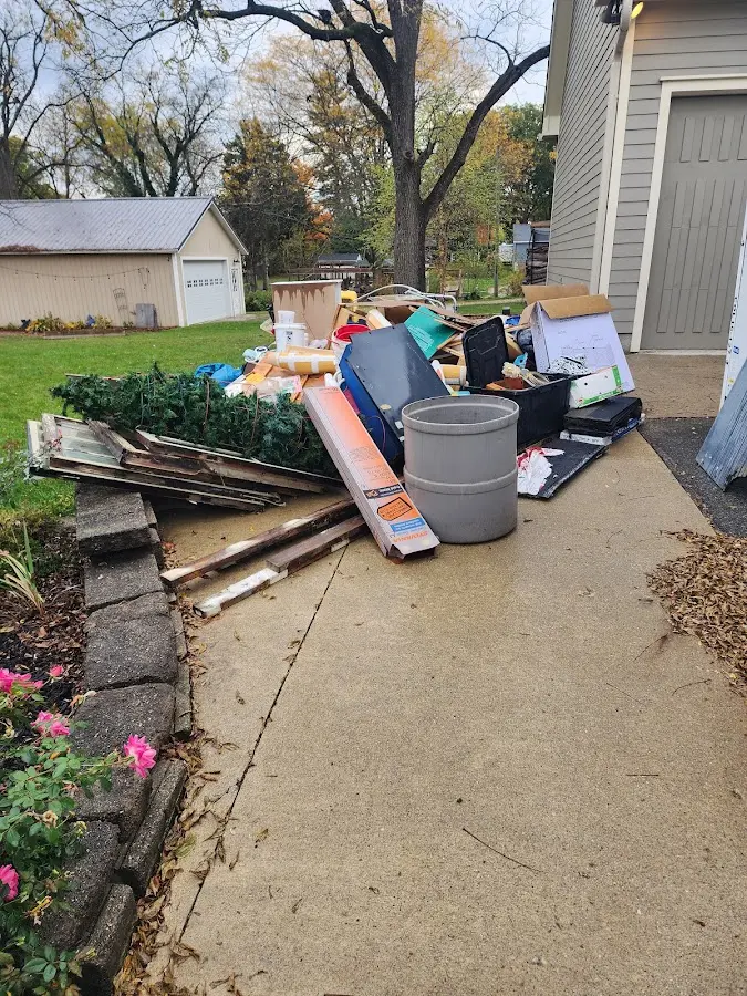 Dumpster being loaded with debris for Roofing Dumpster Rental in Indianola